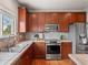 Updated kitchen boasts stainless steel appliances, ample cabinet space, and a sunlit window view at 306 Monares Ln, Erie, CO 80516