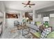 Open-concept living room with a fireplace, comfortable seating, and views into the kitchen creating a seamless living space at 306 Monares Ln, Erie, CO 80516