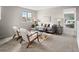 A cozy living room is decorated with stylish furniture, a modern rug, and natural light at 306 Monares Ln, Erie, CO 80516