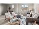 A spacious living room with ample seating, a unique rug, and great natural light at 306 Monares Ln, Erie, CO 80516