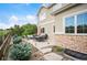 Patio area with dining and seating surrounded by lush landscaping and a wooden fence at 1788 Holmby Ct, Castle Rock, CO 80104