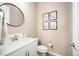 Modern half-bath featuring a vanity with a white countertop, floral artwork, and neutral walls at 1788 Holmby Ct, Castle Rock, CO 80104