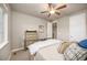 Comfortable bedroom with bright window, ceiling fan, and neutral colored walls at 1788 Holmby Ct, Castle Rock, CO 80104