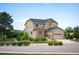 Beautiful home with stone accents, mature trees, and a well-manicured lawn at 1788 Holmby Ct, Castle Rock, CO 80104