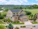 Stunning two-story home showcasing manicured landscaping and stone accents on the exterior in a lush setting at 1788 Holmby Ct, Castle Rock, CO 80104