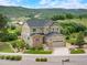 Two-story home with lush landscaping and a view of the mountains at 1788 Holmby Ct, Castle Rock, CO 80104