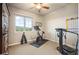 Brightly lit home gym featuring weights, stationary bike, and treadmill with a large window offering scenic views at 1788 Holmby Ct, Castle Rock, CO 80104