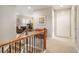 Bright hallway with natural light leads to office space and features a decorative wood and metal banister at 1788 Holmby Ct, Castle Rock, CO 80104
