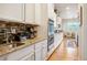 Well-equipped kitchen with granite countertops, mosaic tile backsplash, and stainless steel oven at 1788 Holmby Ct, Castle Rock, CO 80104