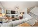 Comfortable living room with fireplace, tv, and staircase to the second level at 1788 Holmby Ct, Castle Rock, CO 80104