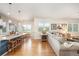 Open-concept living room featuring hardwood floors, neutral walls and decor, and a modern kitchen area at 1788 Holmby Ct, Castle Rock, CO 80104