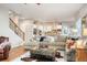 Open-concept living area with a large sectional sofa and view of the kitchen at 1788 Holmby Ct, Castle Rock, CO 80104