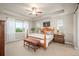 Comfortable bedroom featuring a tray ceiling, ceiling fan, and well-lit windows with scenic views at 1788 Holmby Ct, Castle Rock, CO 80104