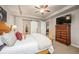 This spacious bedroom includes a large TV and decorative doors leading to the closet at 1788 Holmby Ct, Castle Rock, CO 80104