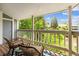 Relaxing balcony with patio furniture and views of lush greenery and trees at 8335 Fairmount Dr # 9-201, Denver, CO 80247