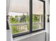 Window with view of trees and lake from balcony at 8335 Fairmount Dr # 9-201, Denver, CO 80247