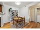 Cozy dining area with wooden table set, shelving, and hardwood floors at 8335 Fairmount Dr # 9-201, Denver, CO 80247