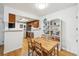Bright dining area with hardwood floors, a light wood dining table, and built-in shelving for storage at 8335 Fairmount Dr # 9-201, Denver, CO 80247