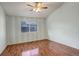 Bedroom with vaulted ceiling, wood floors, and ceiling fan at 1885 S Quebec Way # L102, Denver, CO 80231