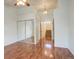 Main bedroom with mirrored closet and access to hallway at 1885 S Quebec Way # L102, Denver, CO 80231