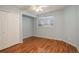 Light blue bedroom with wood floors and double doors at 1885 S Quebec Way # L102, Denver, CO 80231