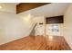 Bright living room with hardwood floors and staircase at 1885 S Quebec Way # L102, Denver, CO 80231