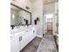 Bathroom featuring double sinks, a large mirror, and access to a walk-in closet at 6235 Stable View St, Castle Pines, CO 80108