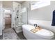 Luxurious bathroom with freestanding tub, separate shower with a glass enclosure, and a view into a walk-in closet at 6235 Stable View St, Castle Pines, CO 80108