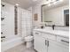 Clean bathroom with a shower-tub combo, white vanity, and modern fixtures at 6235 Stable View St, Castle Pines, CO 80108