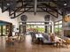 Spacious clubhouse interior featuring modern furnishings, a large dining table, and an outdoor patio view at 6235 Stable View St, Castle Pines, CO 80108