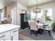 Bright dining area features an elegant chandelier, large windows, and a stylish hutch for storage at 6235 Stable View St, Castle Pines, CO 80108