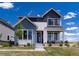 Charming two-story home boasting a mix of siding and stone finishes with beautifully landscaped front yard at 6235 Stable View St, Castle Pines, CO 80108