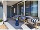 Cozy front porch featuring stylish wicker chairs with striped pillows and a small accent table at 6235 Stable View St, Castle Pines, CO 80108