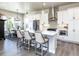 Bright kitchen featuring bar stool seating, white cabinets, stainless steel appliances, and pendant lighting at 6235 Stable View St, Castle Pines, CO 80108