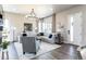 Spacious living room featuring a sectional sofa, modern chandelier, and large windows at 6235 Stable View St, Castle Pines, CO 80108