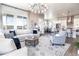 Open-concept living room with views of the dining area, kitchen, and hardwood floors at 6235 Stable View St, Castle Pines, CO 80108