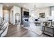 Bright living room features a fireplace, large mirror, modern chandelier and hardwood floors at 6235 Stable View St, Castle Pines, CO 80108