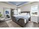 This main bedroom features a blue accent on the ceiling and ample natural light at 6235 Stable View St, Castle Pines, CO 80108