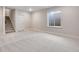 This finished basement has neutral walls and carpet, with a window well for natural light at 3314 N Haleyville Ct, Aurora, CO 80019