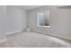 This basement has neutral walls and carpet, plus a window well for natural light at 3314 N Haleyville Ct, Aurora, CO 80019