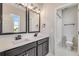 This bathroom has a double vanity with black fixtures and a walk-in shower at 3314 N Haleyville Ct, Aurora, CO 80019