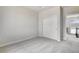 This bedroom features neutral walls and carpet, plus a double-door closet for storage at 3314 N Haleyville Ct, Aurora, CO 80019