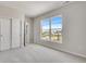 This bedroom includes neutral walls and carpet, plus a window with a view and closet at 3314 N Haleyville Ct, Aurora, CO 80019