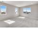 Bright bonus room showcasing neutral paint, plush carpeting, and large windows that provide ample natural light at 3314 N Haleyville Ct, Aurora, CO 80019