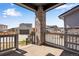 Charming front porch with stone columns and wrought iron railing, offering a cozy outdoor space and neighborhood views at 3314 N Haleyville Ct, Aurora, CO 80019