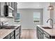Stylish kitchen features stainless steel appliances, modern backsplash, and wood flooring at 3314 N Haleyville Ct, Aurora, CO 80019