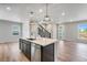 Modern kitchen with stainless steel appliances, a kitchen island, and wood flooring at 3314 N Haleyville Ct, Aurora, CO 80019