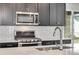 Close up of a stylish kitchen featuring stainless steel appliances and a white tile backsplash at 3314 N Haleyville Ct, Aurora, CO 80019