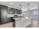 Stylish kitchen with dark cabinets, quartz countertops, subway tile backsplash, and pendant lighting at 3314 N Haleyville Ct, Aurora, CO 80019
