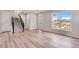 Spacious living room with hardwood floors, staircase, and large windows showcasing natural light and neighborhood views at 3314 N Haleyville Ct, Aurora, CO 80019